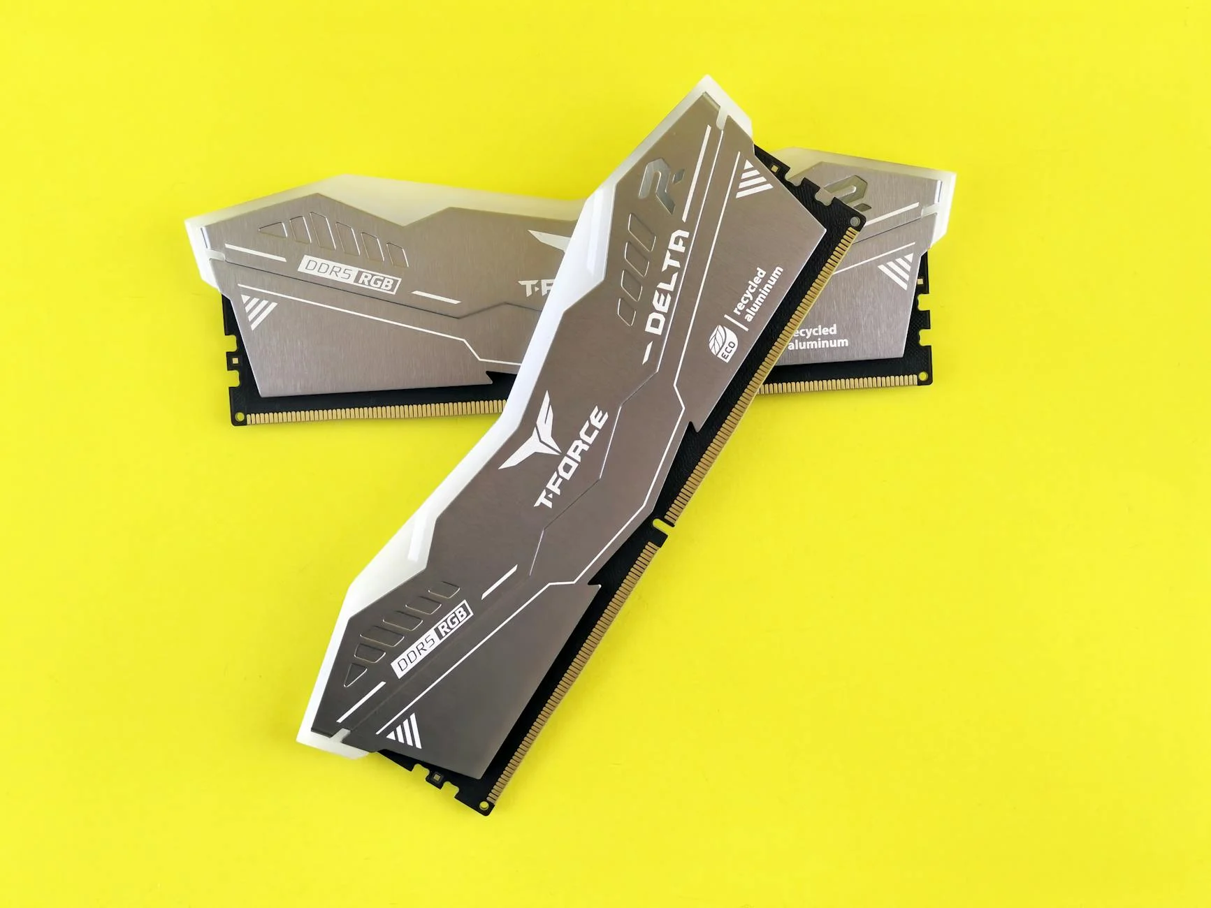 High-performance DDR5 RGB RAM modules featuring sleek design on a vibrant yellow backdrop.